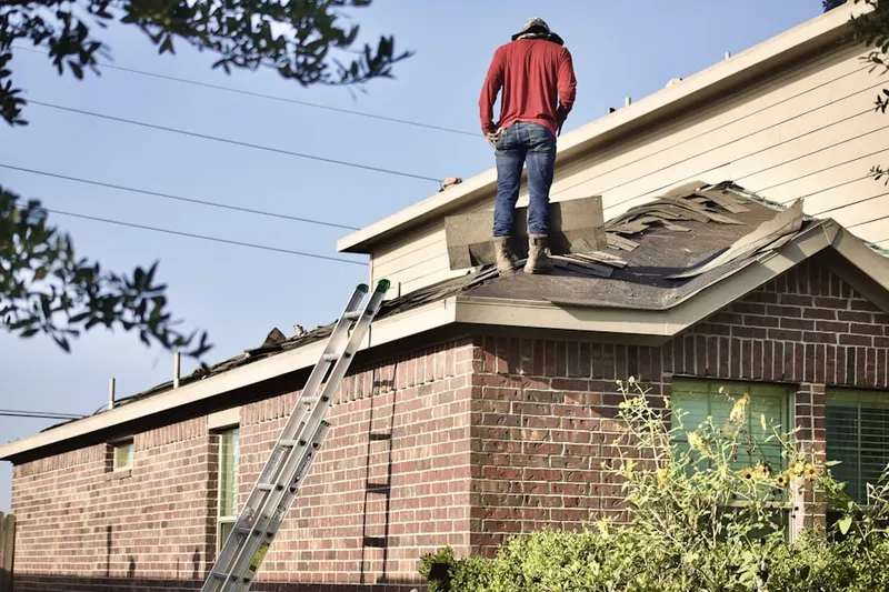 Professional roofer working on a residential roof in Daley